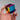 Hand holding the Original 50 mm CMY Cube with overlapping cyan, magenta, and yellow faces