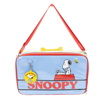 Front view of the blue Peanuts 75th Anniversary Out To Lunch laptop bag with red shoulder strap, Snoopy doghouse artwork, and round charm