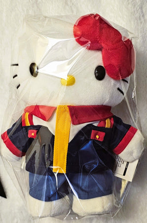 Front close-up of Hello Kitty plush in a navy Gundam uniform sealed in clear packaging